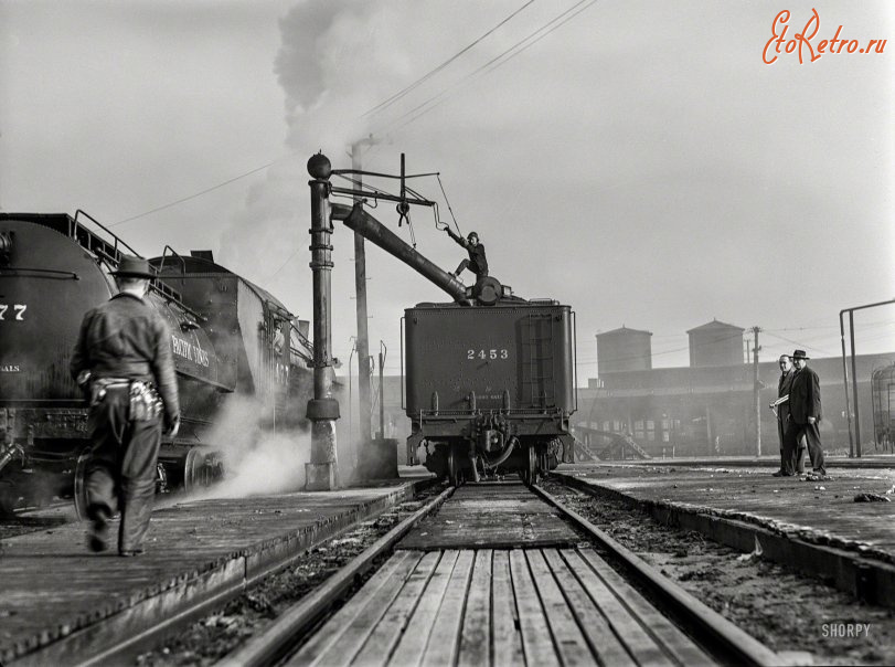 Железная дорога (поезда, паровозы, локомотивы, вагоны) - Женщина-железнодорожник  обеспечивает  водой паровоз